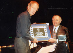 Centenial of British Film Commerative copy plaque being presented by Ron Curry to John Barry, Royal Albert Hall, Saturday 18th April, 1998.